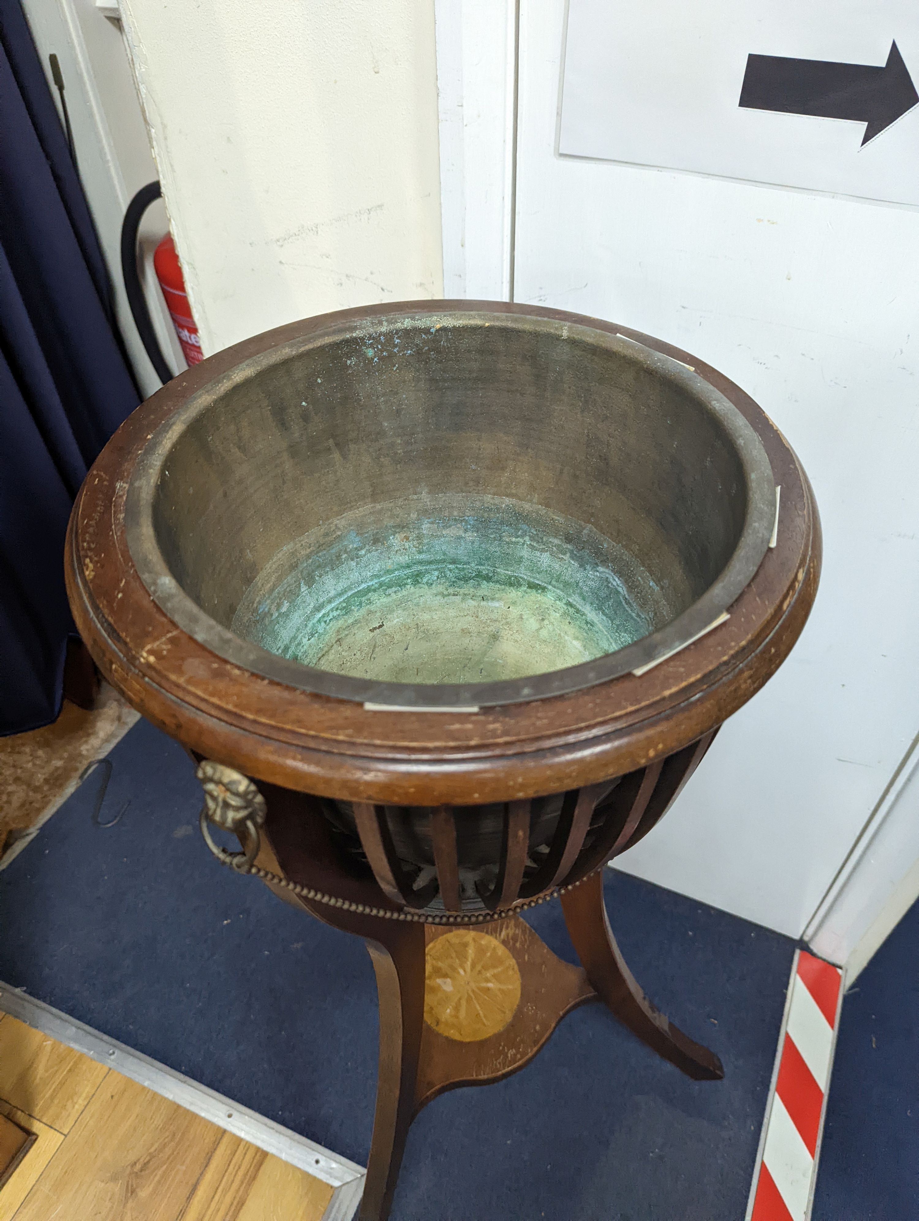 An Edwardian style inlaid mahogany jardiniere with brass liner, diameter 35cm, height 85cm